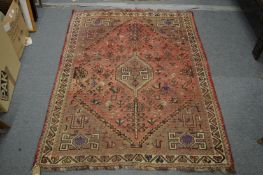 A Persian carpet, pink ground with stylised decoration including birds and trees 153cm x 117cm.