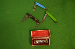 Three miniature pen knives and a boxed miniature harmonium (little band master).