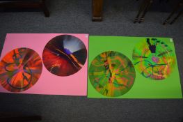 In the manner of Damien Hirst, a pair of double circular spin paintings, unframed.