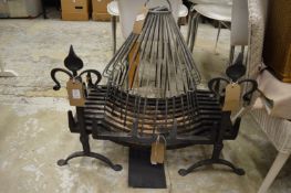 A cast iron fire grate with wrought iron fire dogs and another items.