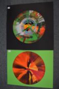 In the manner of Damien Hirst, two circular spin paintings, unframed.