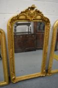 A large decorative mirror with shaped cresting.