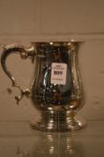A silver baluster shaped tankard.