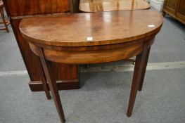 A 19th century mahogany demi-lune fold-over card table.