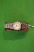 A ladies Omega Constellation stainless steel wrist watch with diamond set bezel.