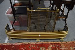 A heavy brass spark guard and a brass fender.