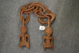 An unusual carved wood chain with figural ends.