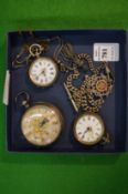 Three silver pocket watches with chains and fob.