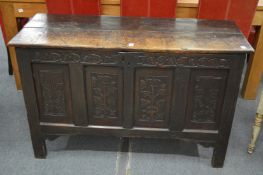 A 17th century oak coffer with carved frieze and panels.
