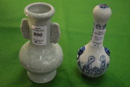 A small Chinese celadon glazed bottle vase and a blue and white bottle vase.