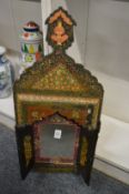 An Islamic painted lacquer wall mirror with folding doors.