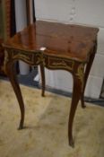 A decorative French style occasional table.