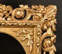 A 19th Century carved frame with oval aperture, rebate size 16.5