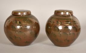 A pair of glazed studio pottery jars with covers, both around both around 5.5