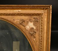 A 19th Century gilt frame with decorative spandrels and inset oval glass, rebate size 30
