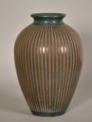 Roger Calero, Nicaragua, a green vase with incised textured decoration, signed, 13.5
