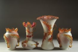 A GARNITURE OF FOUR OPAQUE GLASS VASES with applied leaves and fruit. 12ins, 9ins and 7ins high.