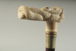 A WALKING STICK WITH CARVED BONE HANDLE 