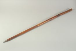 AN EARLY WOODEN CASED SWORD STICK with engraved blade. 3ft long.