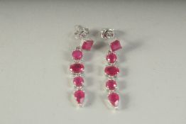 A PAIR OF SILVER RUBY SET LONG DROP EARRINGS, boxed.