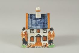 A PRATT WARE POTTERY HOUSE with blue roof, two men standing at the side of the house. 4.5ins high.