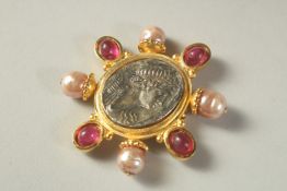A BROOCH BY LINDA LEVINSON.
