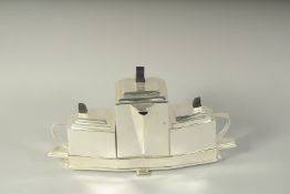 A SILVER PLATE ART DECO DESIGN TEA SET on a stand.