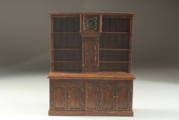 A GOOD 18TH DESIGN OAK MINIATURE WELSH DRESSER, the top with three shelves either side of a clock,