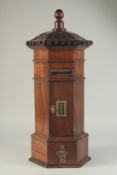A SMALL GEORGIAN STYLE MAHOGANY OCTAGONAL POST BOX with brass letter flap, panel door and small