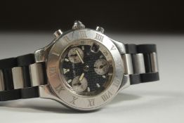 A CARTIER CHRONOGRAPH with three subsidiary dials and leather strap.