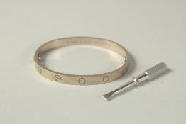 AN 18CT WHITE GOLD CARTIER BANGLE with screwdriver, No. GSD 066 AU 750. 6cm x 5cm, weight 39.5 gms