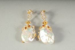 A PAIR OF SILVER 18CT GOLD PLATED BAROQUE PEARL AND GARNET DROP EARRINGS, boxed.