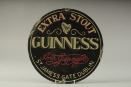 A GUINNESS ENAMEL SIGN. 12ins diameter.