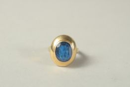 AN 18CT GOLD BLUE STONE RING.