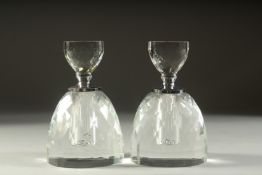 A PAIR OF CIRCULAR CUT GLASS DECANTERS AND STOPPERS. 5.5ins high.