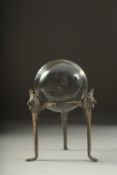 A CRYSTAL BALL, 3ins diameter, on a metal stand.