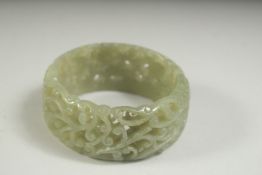 A GOOD PIERCED CELADON JADE BANGLE. 2.75ins.