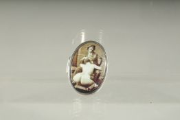 A SILVER PILL BOX, the lid with a painter and model. 3.5cms x 2.5cms.