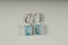 A PAIR OF SILVER, EMERALD CUT BLUE TOPAZ EARRINGS, boxed.