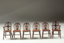 A SET OF TWO CARVING AND FOUR SINGLE 18TH CENTURY DESIGN OAK MINIATURE WINDSOR CHAIRS with spindle