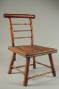 A CHILD'S BAMBOO BATH CHAIR. 13ins high.