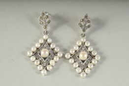 A PAIR OF SILVER AND PEARL EARRINGS, boxed.