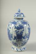 A CHINESE BLUE AND WHITE PORCELAIN JAR AND COVER. 21cms high.