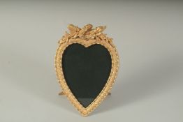 A SINGLE GILT METAL HEART SHAPED PHOTOGRAPH FRAME.