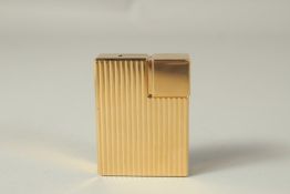 A VERY GOOD GILT METAL CARTIER LIGHTER. No. 448351 in a red Cartier box.
