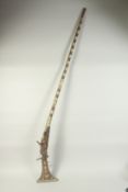 AN INDIAN INLAID AND METAL MOUNTED FLINTLOCK GUN. 5ft 2ins long.