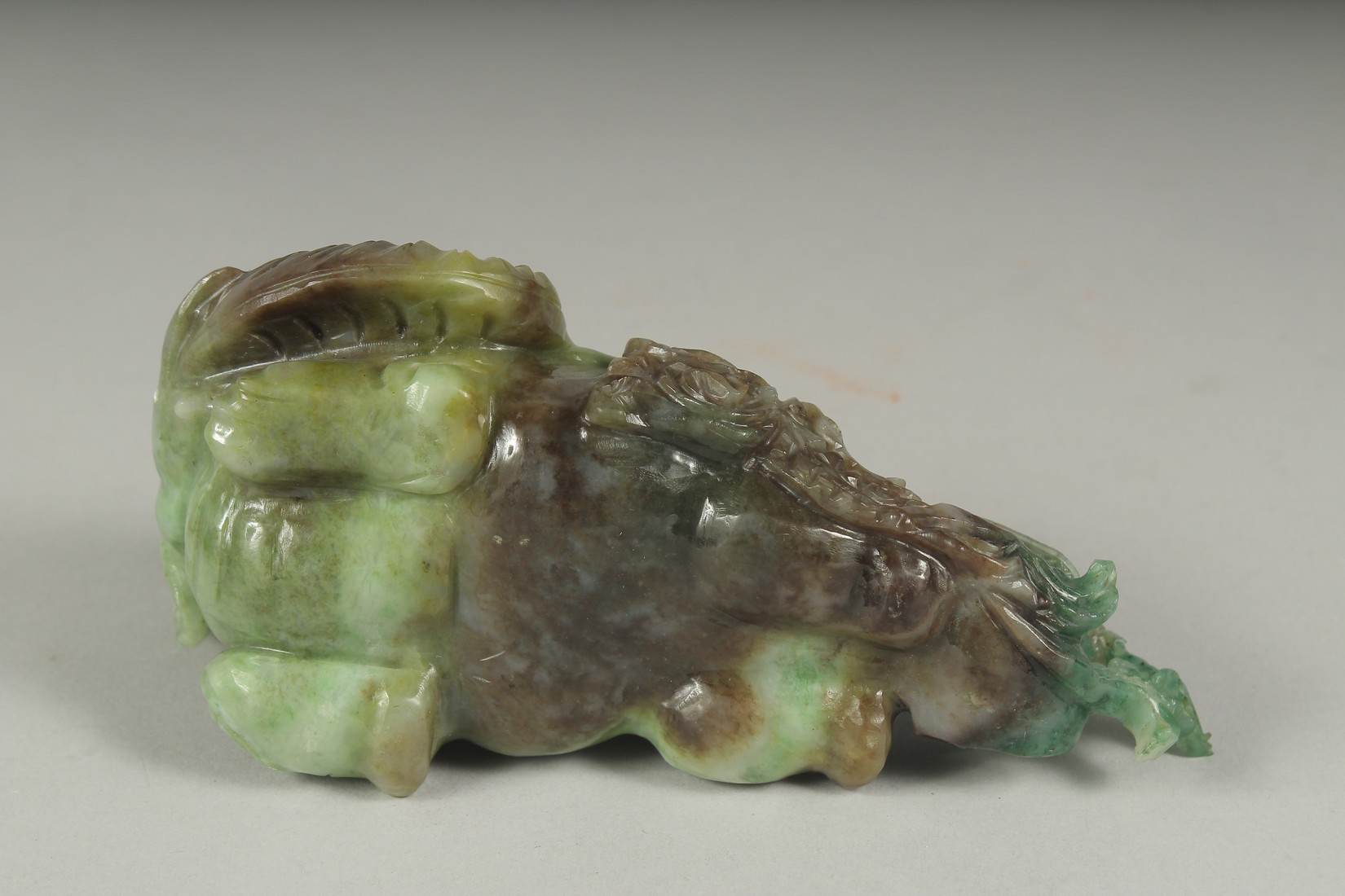 A CHINESE CARVED JADE FIGURE OF AN ELEPHANT ON A FITTED CARVED HARDWOOD STAND, figure 14cm long. - Image 3 of 4