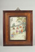 A CHINESE REPUBLIC FAMILLE ROSE PORCELAIN PLAQUE, inset within a hardwood frame, panel depicting