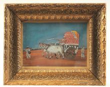 AN 19TH CENTURY INDIAN PAINTING ON MICA, depicting an oxen drawn kart, within a gilt frame and