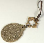 A TIBETAN HANGING BRASS CALENDAR.